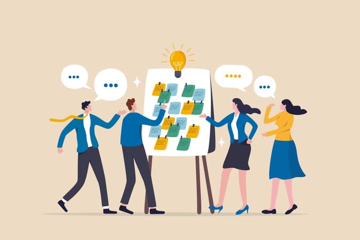 business people in workshop meeting room with whiteboard