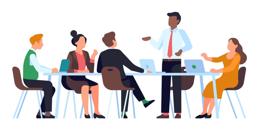 Colleagues sit at table and communicate