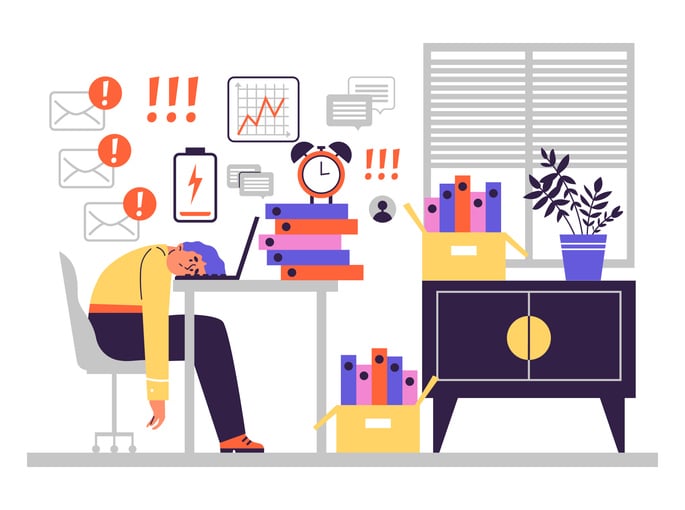 Illustration of exhausted office worker slumped at desk surrounded by urgent emails, low battery icon, and stacks of documents.