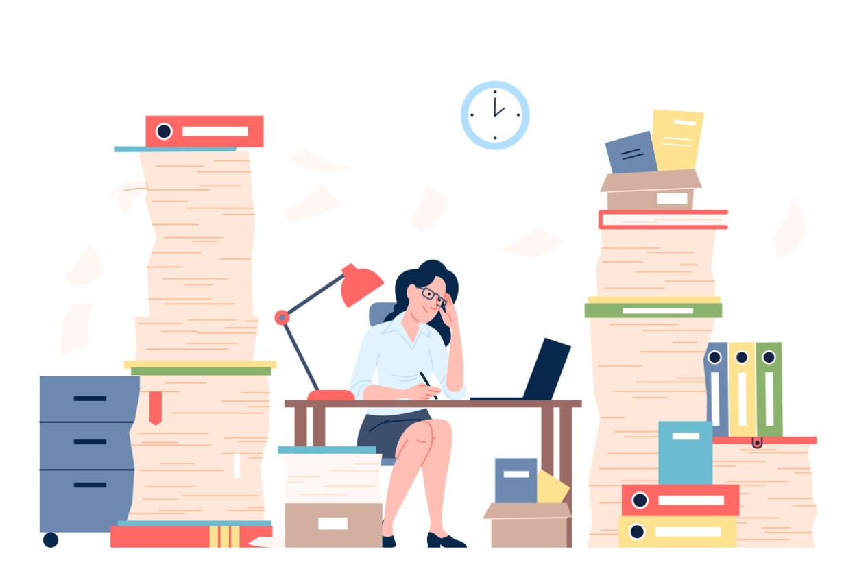Illustration of overwhelmed office worker surrounded by stacks of paperwork, holding forehead in stress.